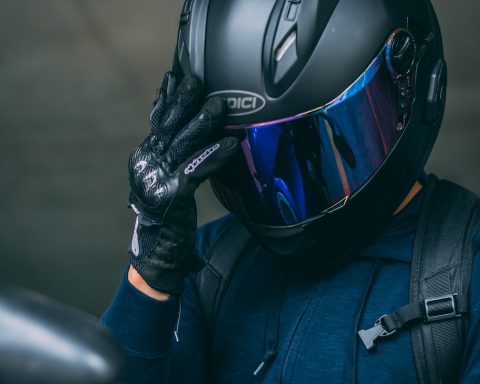 person in black helmet and blue jacket