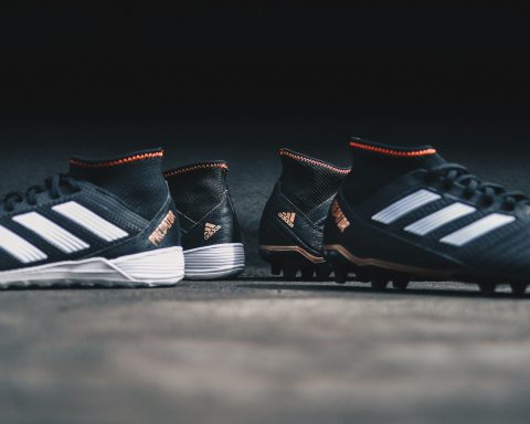 pair of black Adidas cleats