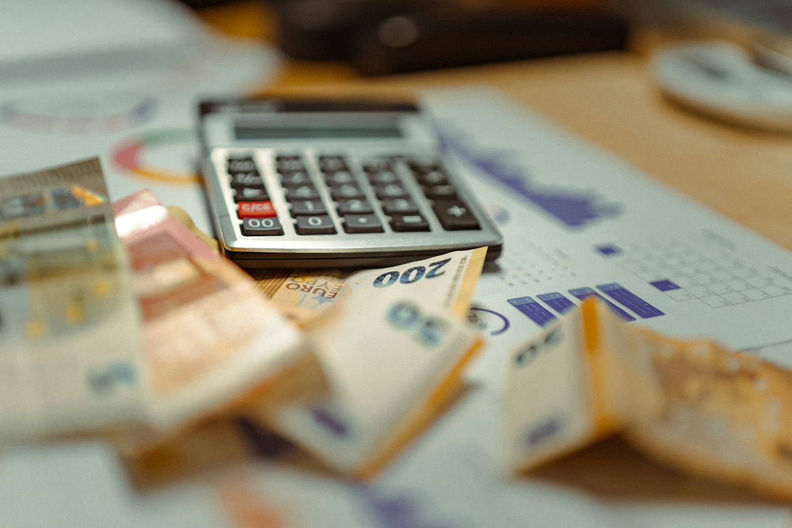 A calculator sitting on top of a pile of money