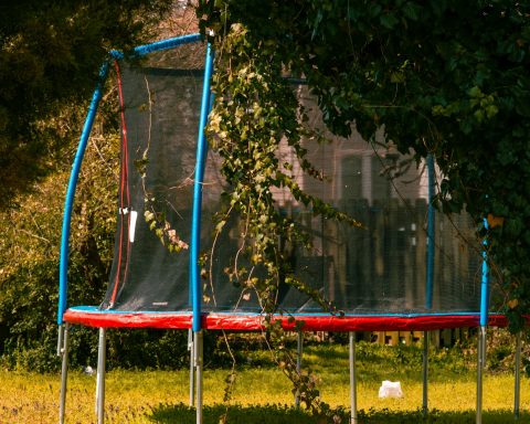 red and blue trampoline with net